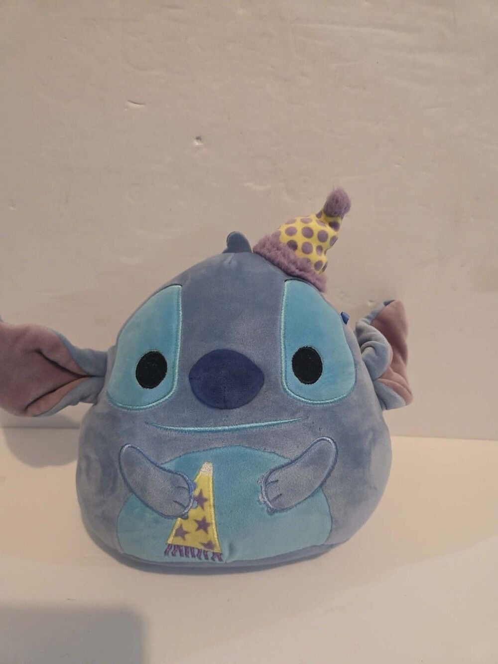 Squishmallows Disney Birthday Stitch wearing hat holding party favor 8"